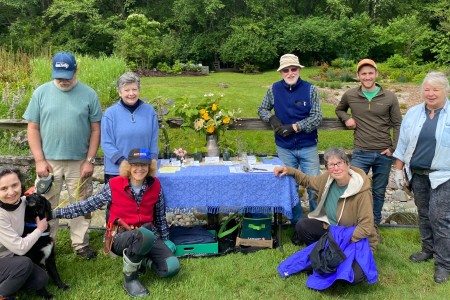 Volunteers take a break on a work party in June