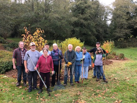 A group of gardeners with their tools.